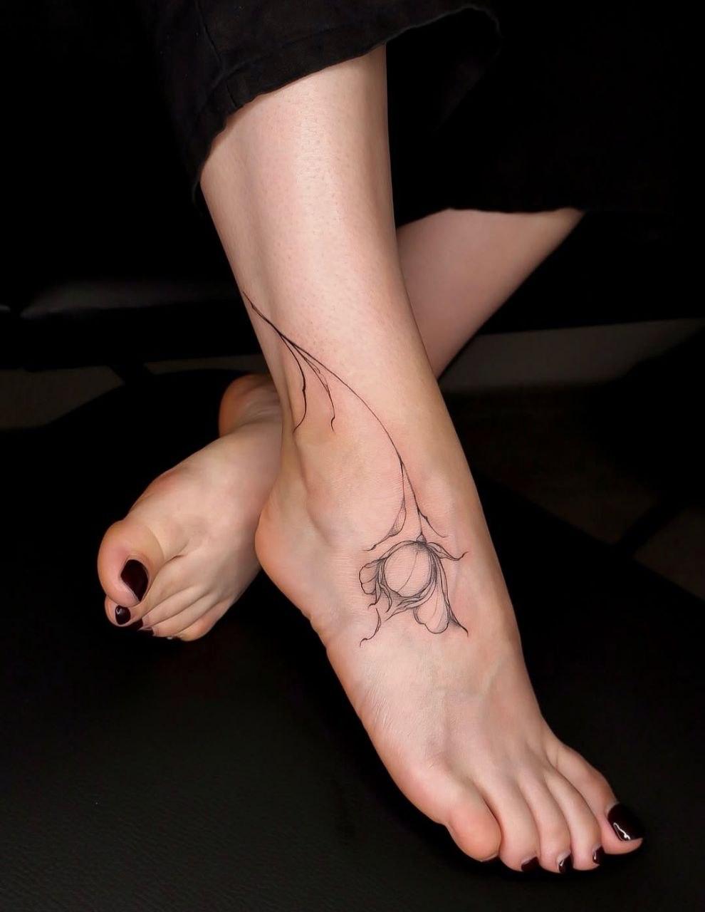 Traditional spider with human face tattoo on arm